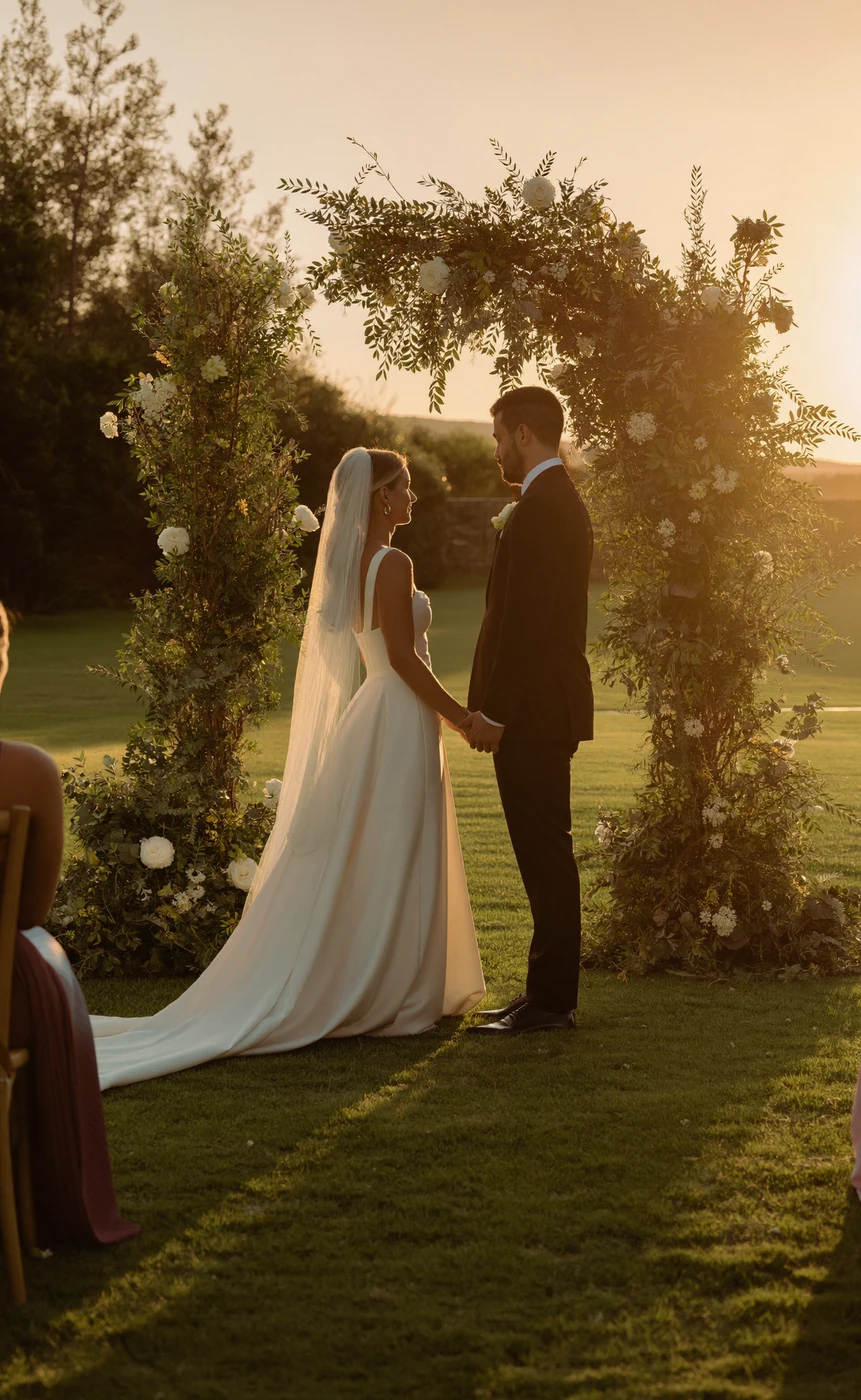 Outdoor Cleveland wedding ceremony beneath a floral arch