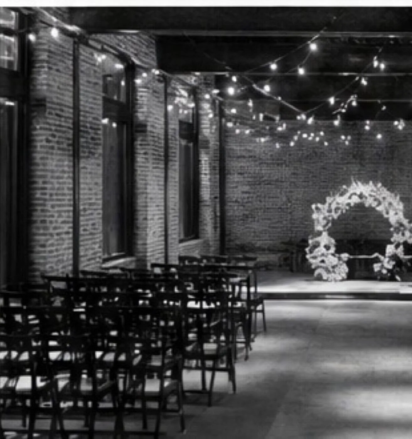 Industrial warehouse wedding venue with floral arch