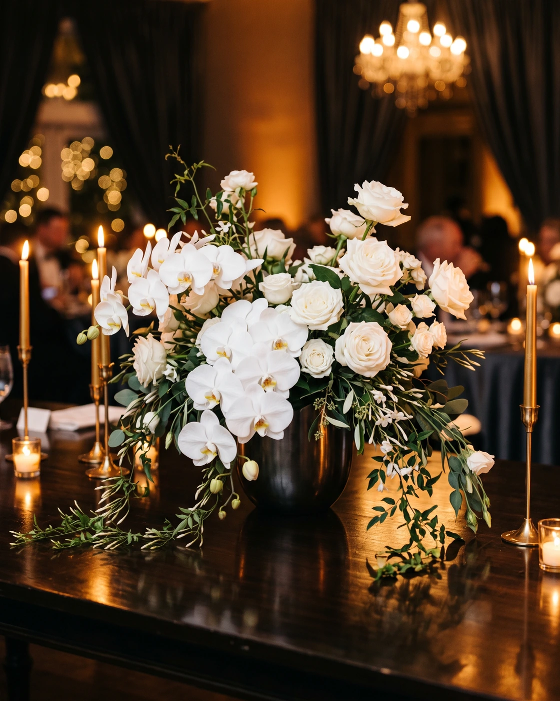 A modern white-orchid centerpiece in warm candlelight, Rock and Roll Hall of Fame Cleveland wedding photographer